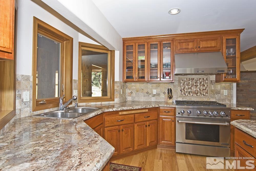 650 Raymond View Road Markleeville, CA 96120 - Photo 13 of 37 a kitchen with stainless steel appliances granite countertop a stove a sink and a microwave