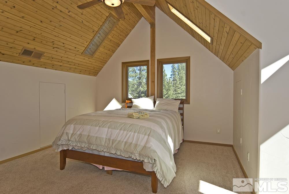 650 Raymond View Road Markleeville, CA 96120 - Photo 27 of 37 a bedroom with a bed and a large window