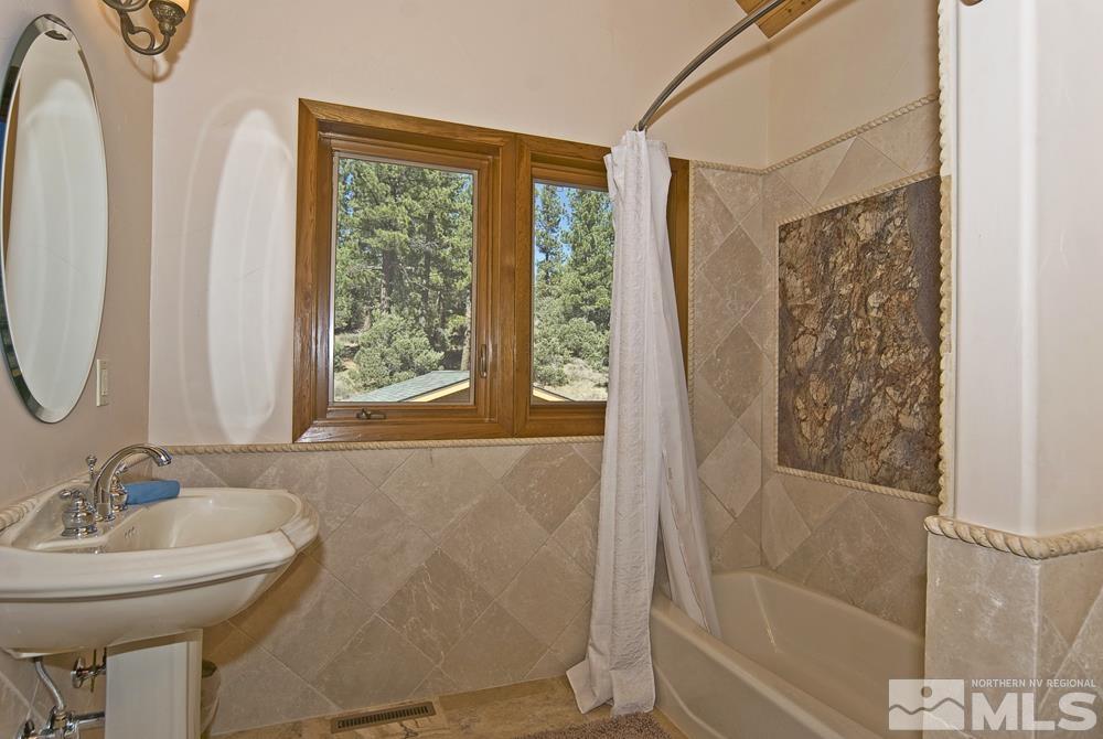 650 Raymond View Road Markleeville, CA 96120 - Photo 28 of 37 a bathroom with a granite countertop sink toilet and shower