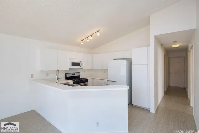 a kitchen with sink a refrigerator and cabinets