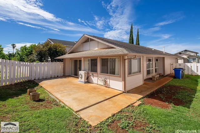 a view of a house with backyard and porch