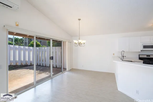 a view of a kitchen with a sink a refrigerator and window