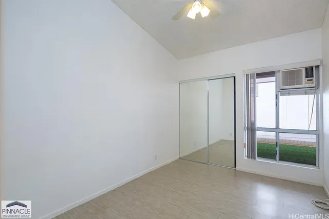 an empty room with windows and closet