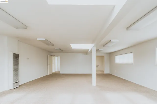 an empty room with a empty space and windows
