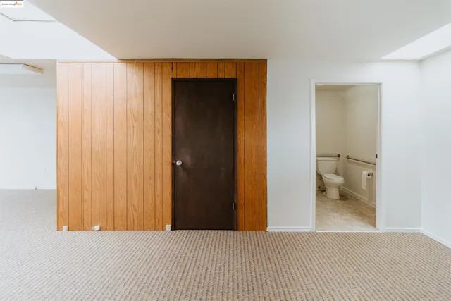 a bedroom with a bed and a bathroom