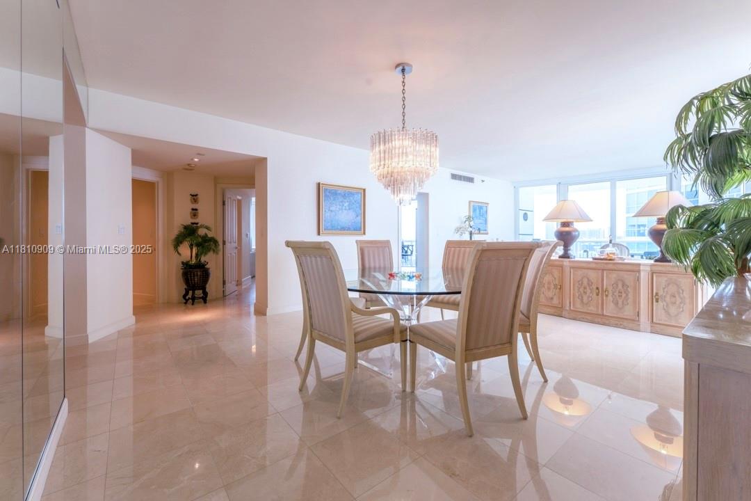 2127 Brickell Avenue, Unit 3304 Miami, FL 33129 - Photo 11 of 39 a view of a dining room and livingroom with furniture wooden floor a chandelier