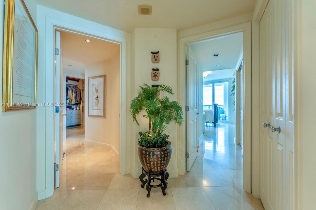 2127 Brickell Avenue, Unit 3304 Miami, FL 33129 - Photo 16 of 39 a view of a hallway with wooden floor and a mirror