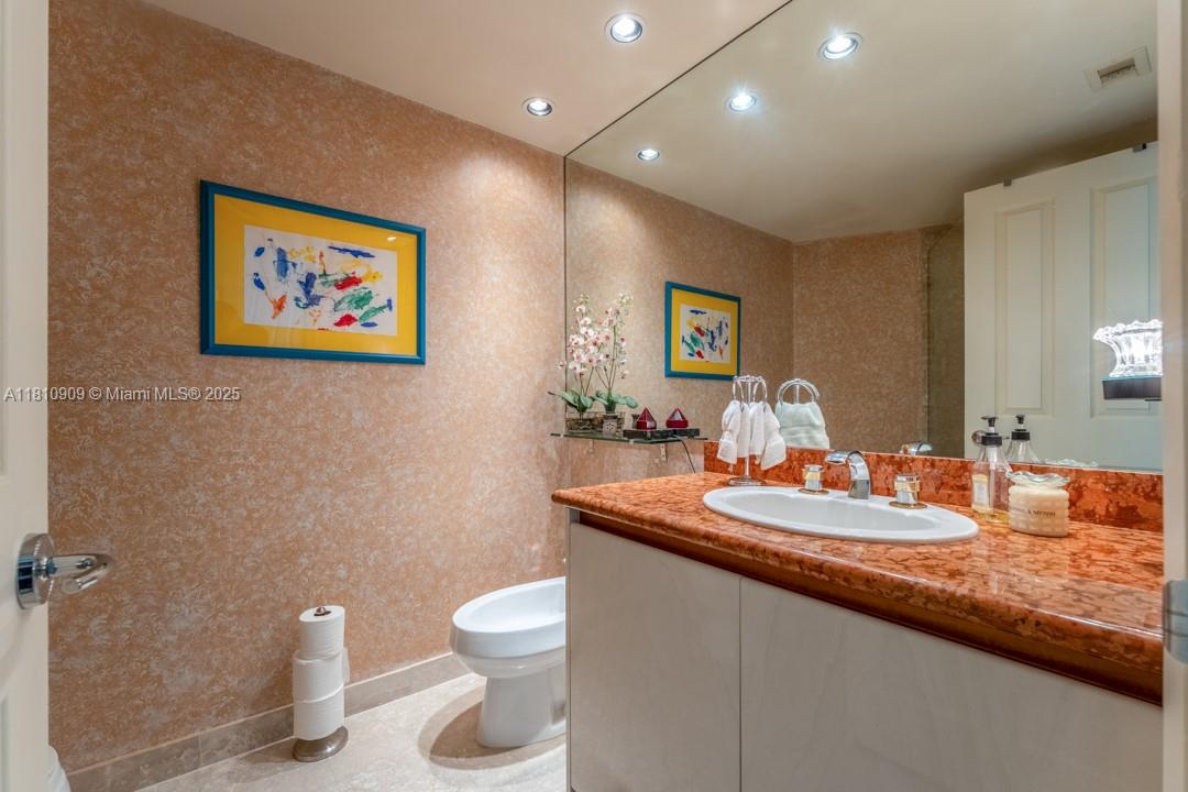 2127 Brickell Avenue, Unit 3304 Miami, FL 33129 - Photo 17 of 39 a bathroom with a toilet sink and mirror