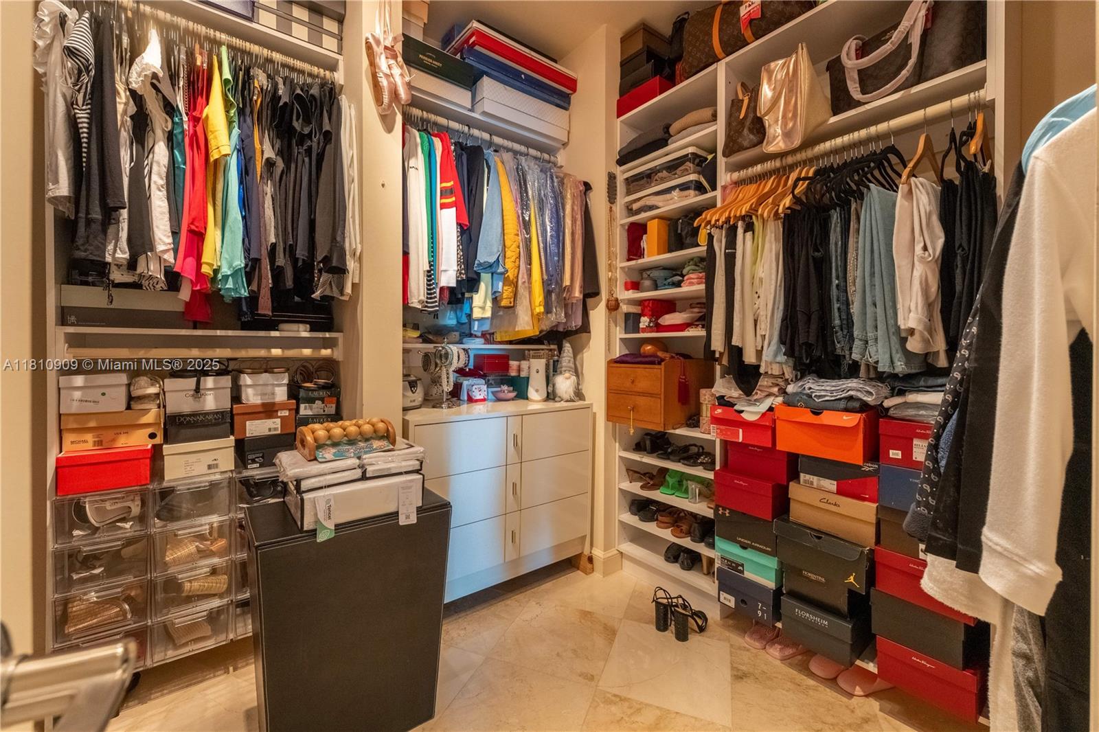 2127 Brickell Avenue, Unit 3304 Miami, FL 33129 - Photo 23 of 39 a view of walk in closet with clothes and shoes