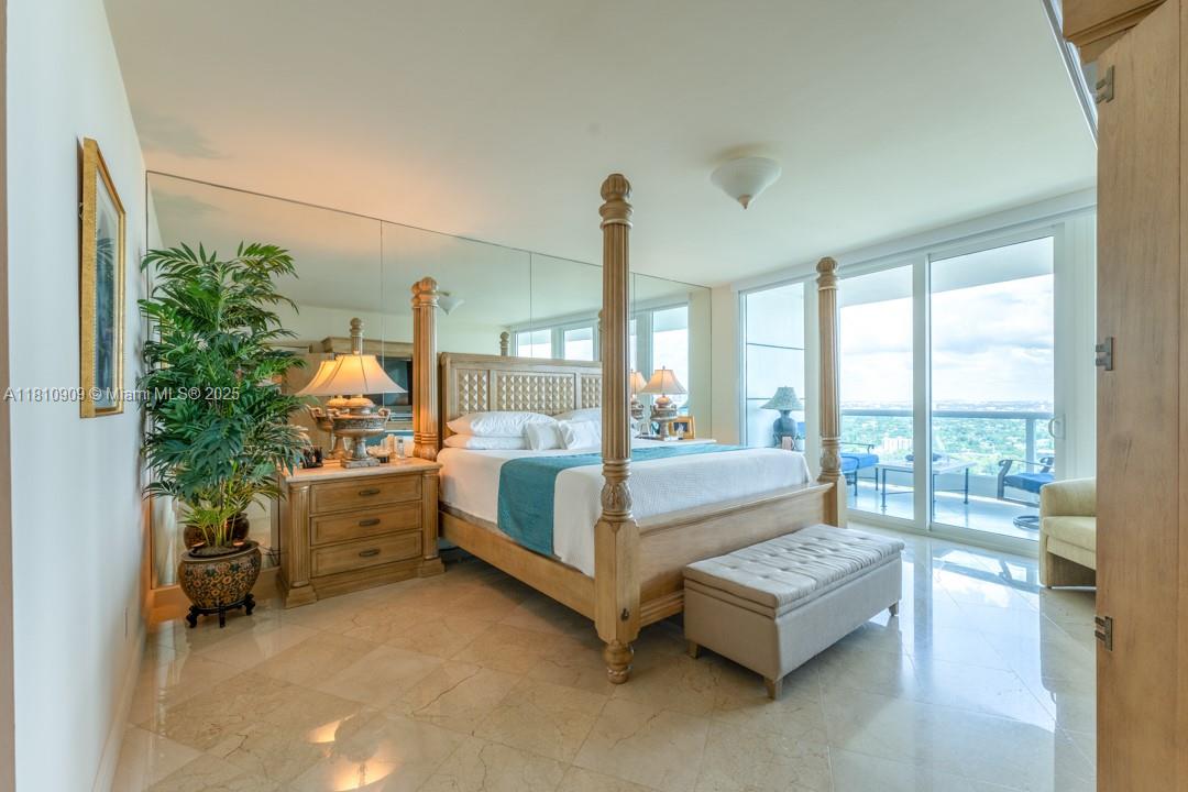 2127 Brickell Avenue, Unit 3304 Miami, FL 33129 - Photo 24 of 39 a bedroom with furniture and large windows
