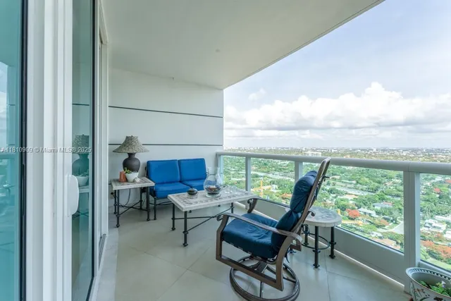 a living room with furniture a rug and a large window