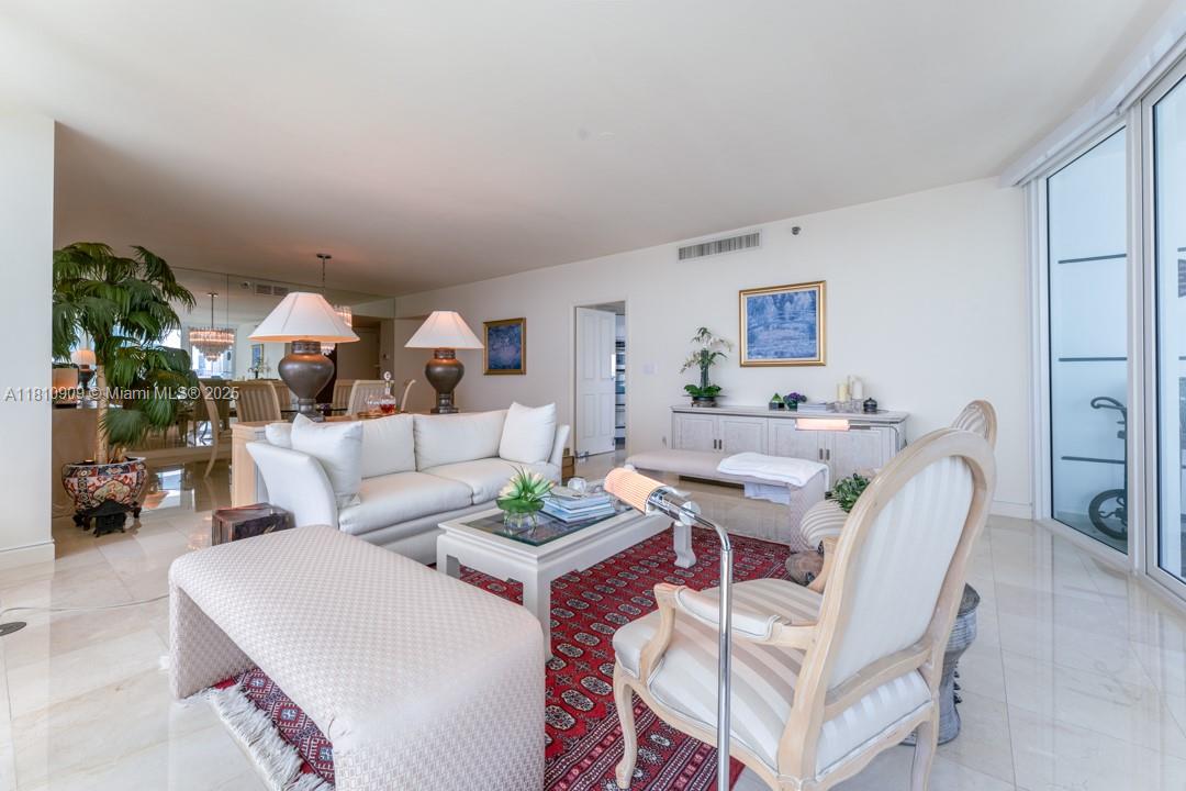 2127 Brickell Avenue, Unit 3304 Miami, FL 33129 - Photo 3 of 39 a living room with furniture and a wooden floor