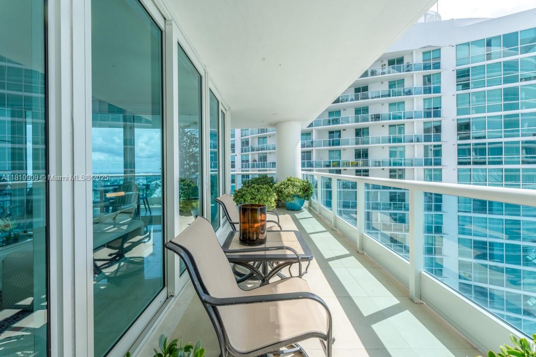 2127 Brickell Avenue, Unit 3304 Miami, FL 33129 - Photo 5 of 39 a view of a balcony with chair and table