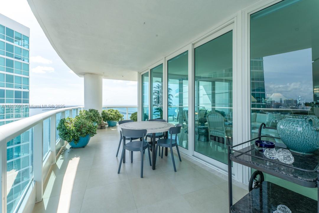 2127 Brickell Avenue, Unit 3304 Miami, FL 33129 - Photo 6 of 39 a balcony with chairs and a table