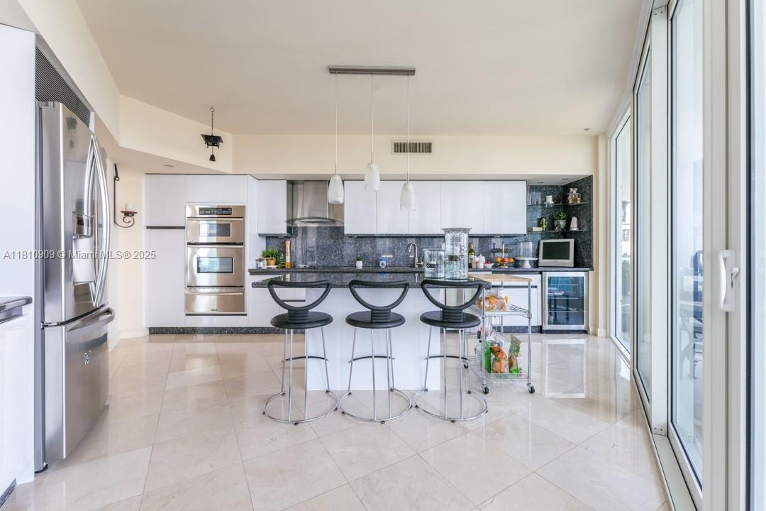 2127 Brickell Avenue, Unit 3304 Miami, FL 33129 - Photo 7 of 39 a view of a kitchen with stainless steel appliances cabinets and a refrigerator