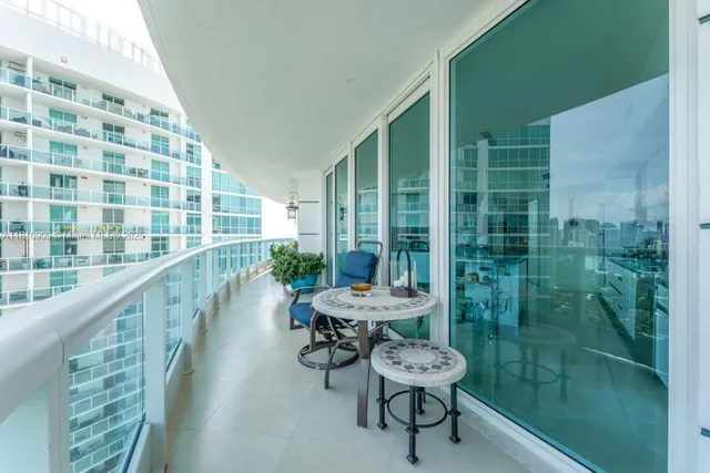 a balcony with chairs and table