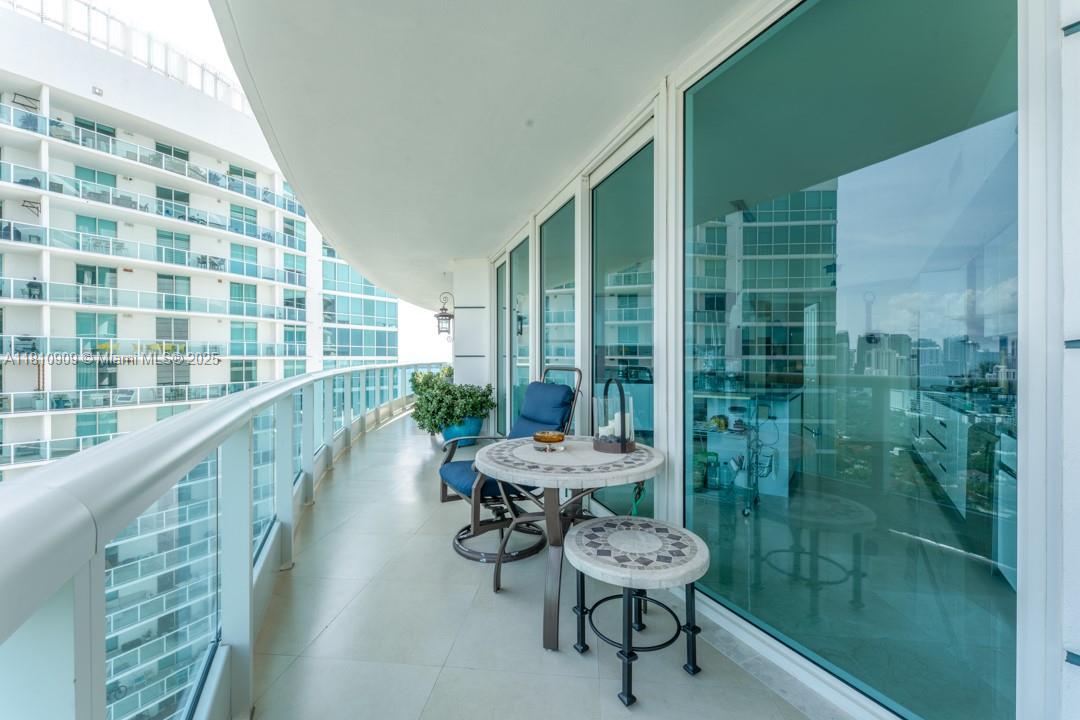 2127 Brickell Avenue, Unit 3304 Miami, FL 33129 - Photo 10 of 39 a balcony with chairs and table