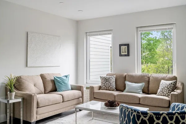 a living room with furniture and a large window
