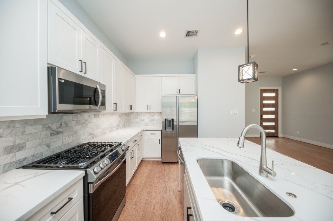 1860 West Tidwell Road Houston, TX 77091 - Photo 14 of 32 a kitchen that has a sink a stove and microwave