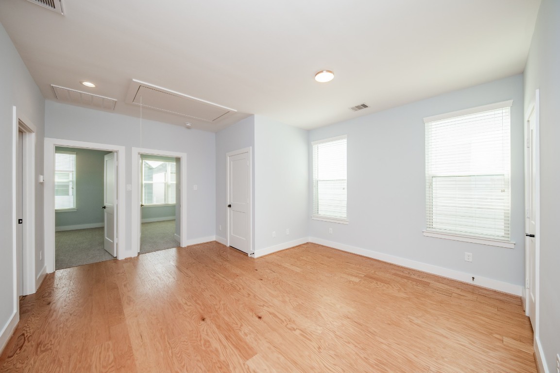 1860 West Tidwell Road Houston, TX 77091 - Photo 16 of 32 a view of an empty room with wooden floor and a window