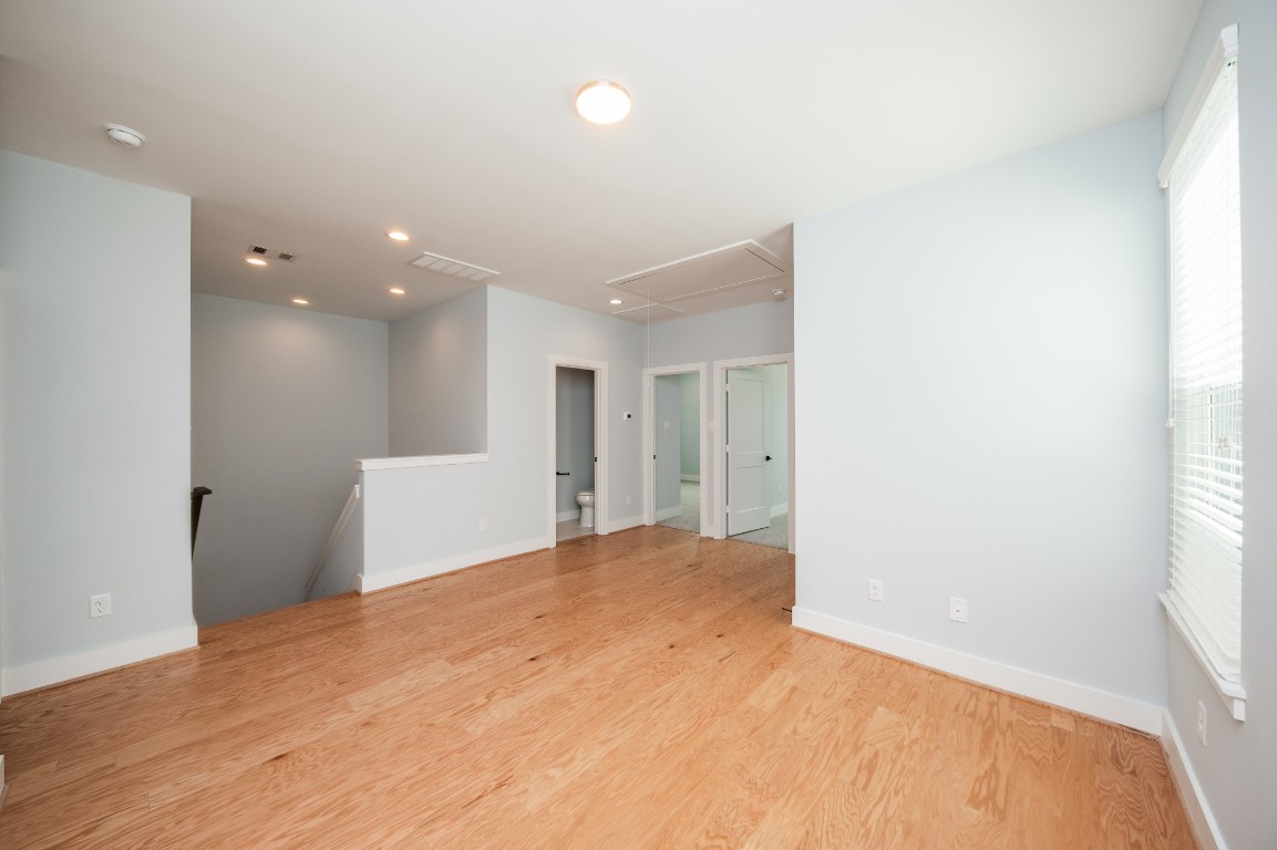1860 West Tidwell Road Houston, TX 77091 - Photo 17 of 32 a view of a big room with wooden floor and windows