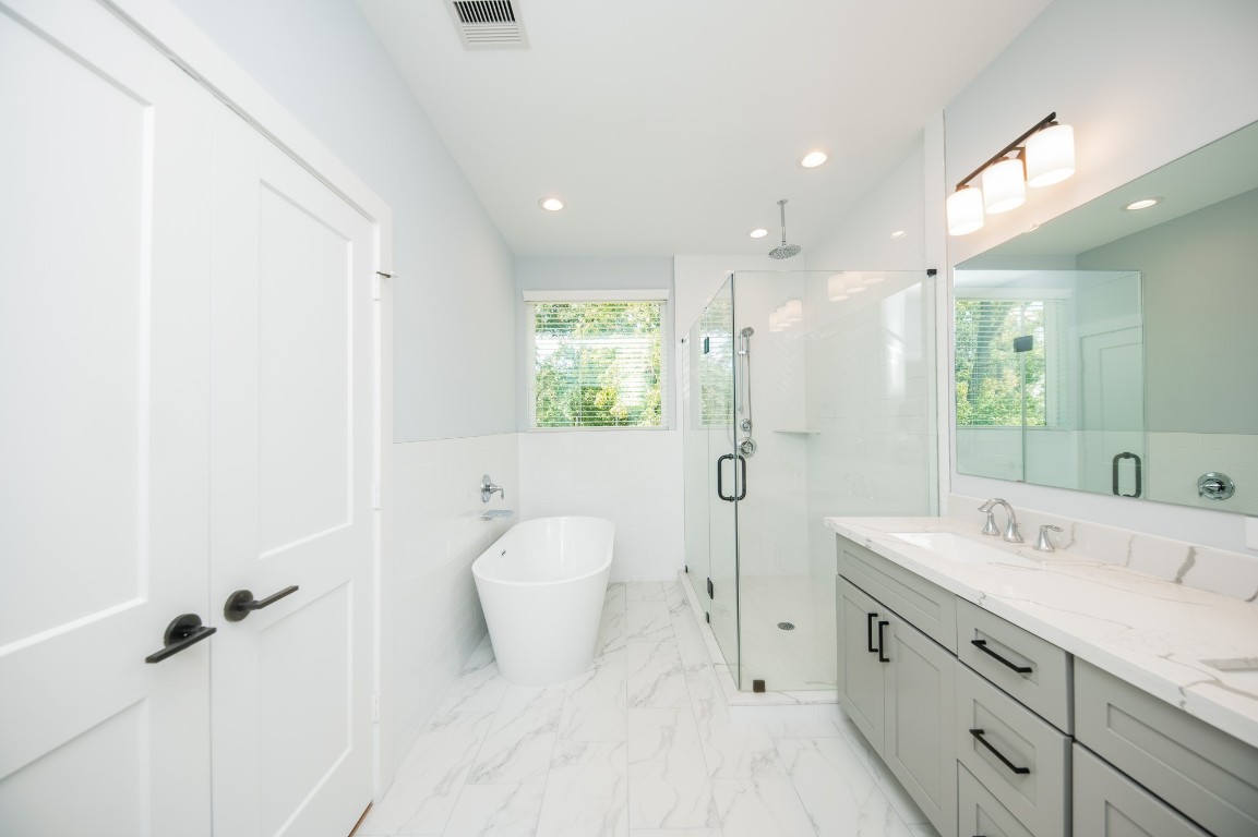 1860 West Tidwell Road Houston, TX 77091 - Photo 28 of 32 a spacious bathroom with a double vanity sink toilet and shower
