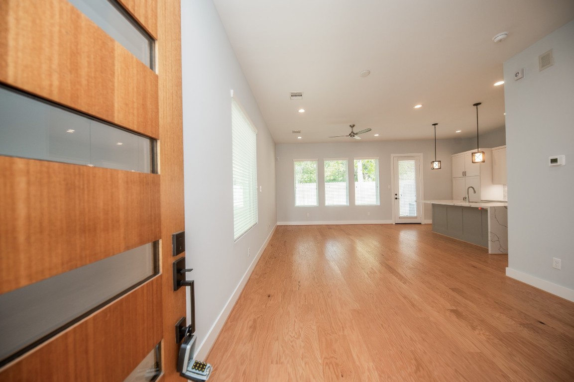1860 West Tidwell Road Houston, TX 77091 - Photo 5 of 32 a view of an empty room with wooden floor and a window