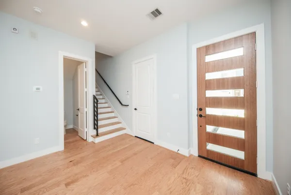 a view of an entryway with wooden floor