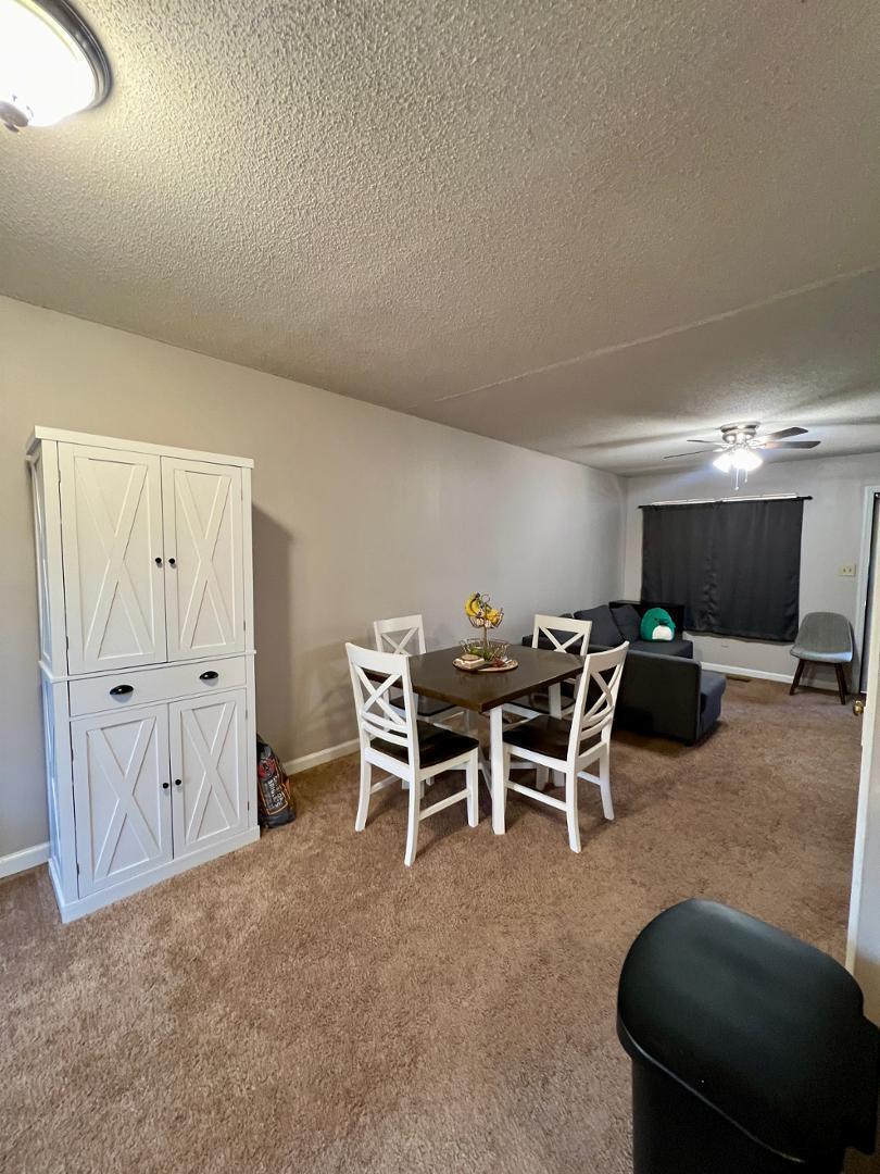 821 Barringer Drive, Unit A Raleigh, NC 27606 - Photo 3 of 8 a dining room with furniture and a chandelier