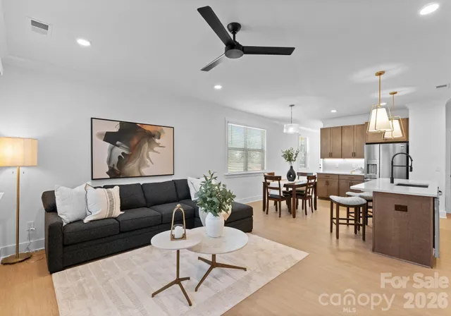 a living room with furniture kitchen view and a dining table