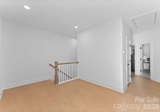 a view of hallway with wooden floor