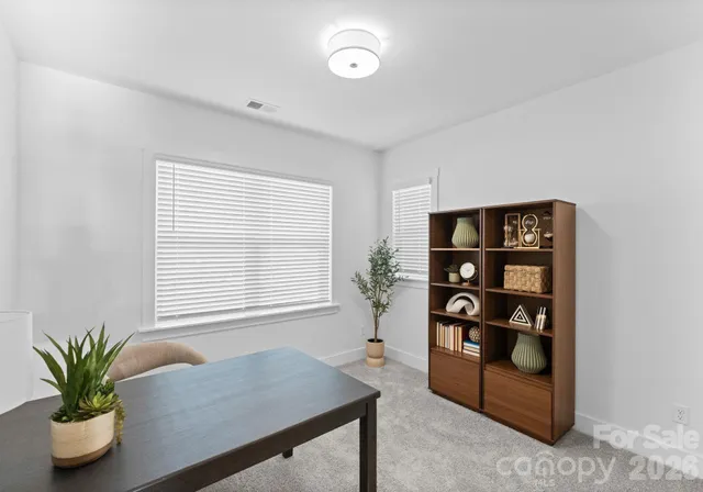 a view of a big room with windows and cabinet