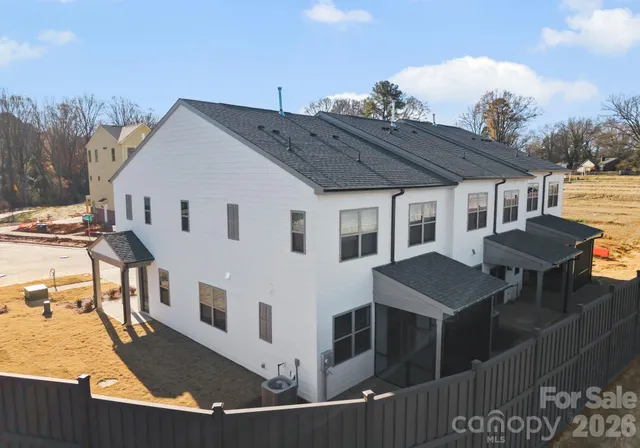a view of a white house with a sink and table