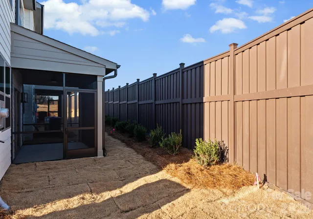 a view of a backyard with potted plants