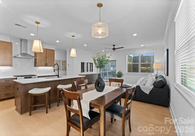 a large kitchen with a table and chairs