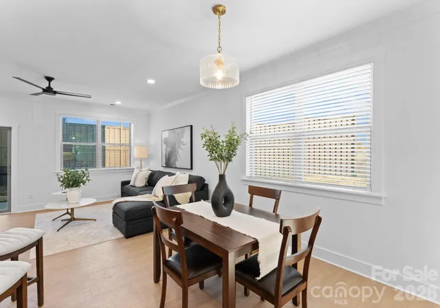 a living room with furniture a chandelier and a window