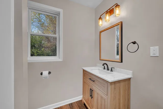 a bathroom with 2 sink and a mirror
