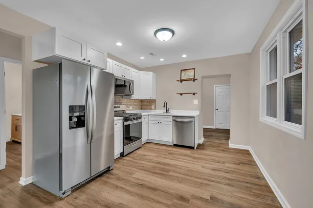 a kitchen with stainless steel appliances a refrigerator and a stove top oven