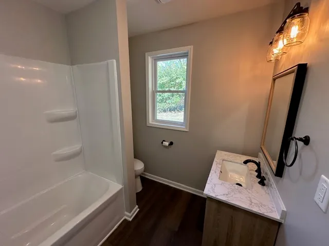 a bathroom with a bathtub sink and toilet