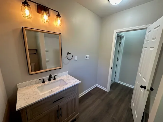 a bathroom with a granite countertop sink vanity and a mirror