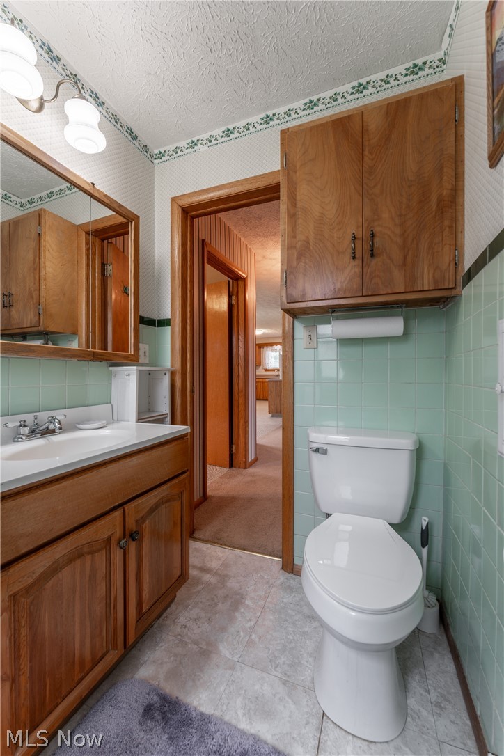 4833 Angling Road Wooster, OH 44691 - Photo 27 of 49 Bathroom featuring tile walls, tile flooring, and toilet