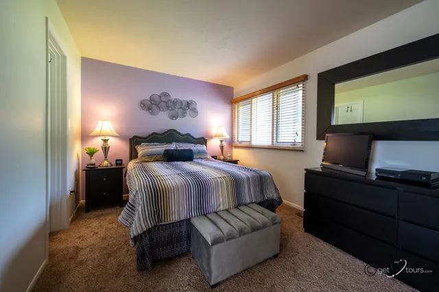 a bedroom with a bed and window