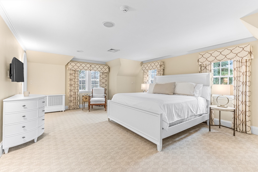 409 Heath Street Brookline, MA 02467 - Photo 13 of 29 a bedroom with a large bed and a tv
