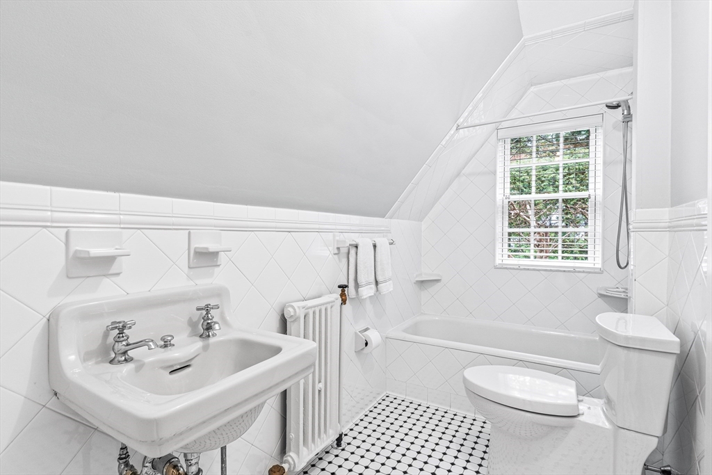 409 Heath Street Brookline, MA 02467 - Photo 20 of 29 a bathroom with a sink toilet and shower