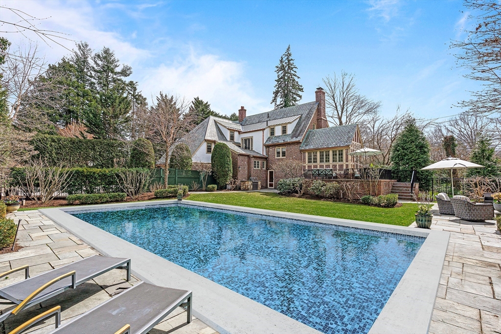 409 Heath Street Brookline, MA 02467 - Photo 2 of 29 a view of a house with pool and chairs