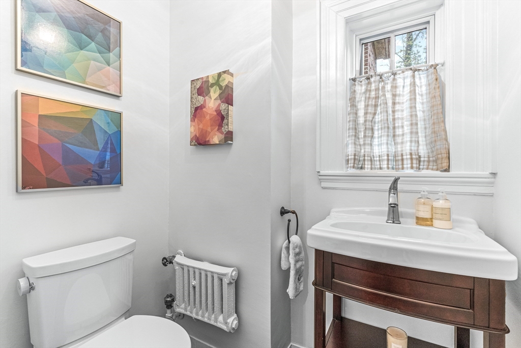 409 Heath Street Brookline, MA 02467 - Photo 23 of 29 a bathroom with a toilet a sink and a window