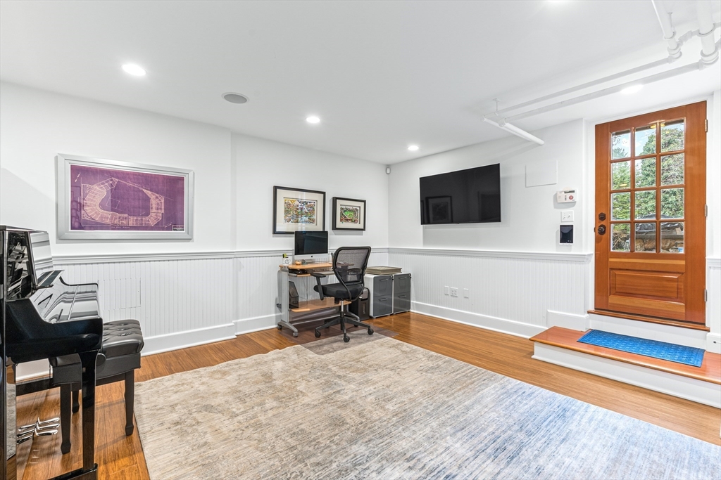 409 Heath Street Brookline, MA 02467 - Photo 24 of 29 a living room with furniture and a flat screen tv