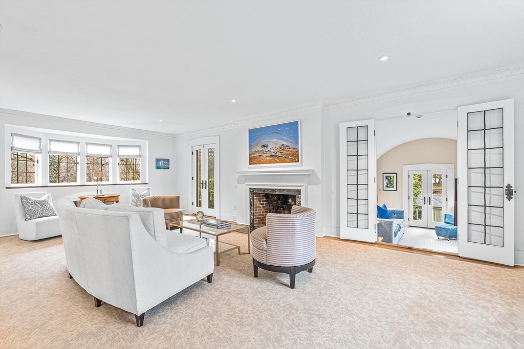 409 Heath Street Brookline, MA 02467 - Photo 4 of 29 a living room with furniture and a fireplace
