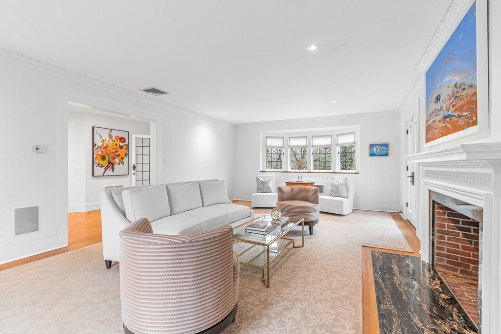 409 Heath Street Brookline, MA 02467 - Photo 5 of 29 a living room with furniture a fireplace and a large window
