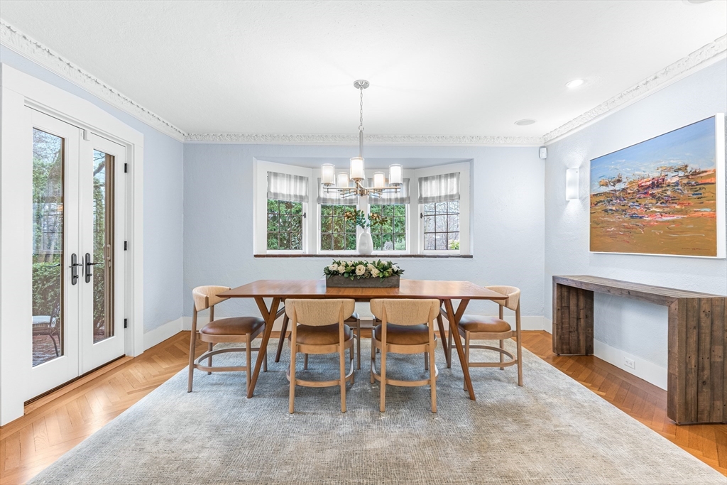 409 Heath Street Brookline, MA 02467 - Photo 7 of 29 a dining room with furniture a chandelier and wooden floor